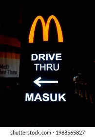 Cirebon, Indonesia - June 06: 2021 Entrance Sign For Drive Thru At Mcdonalds At Night, Concept Of Food Pickup Without Getting Out Of The Vehicle.