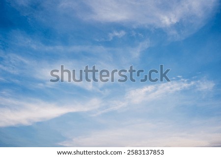 Cirrus cloud with sunset light over blue sky.  nature wallpaper  background.
