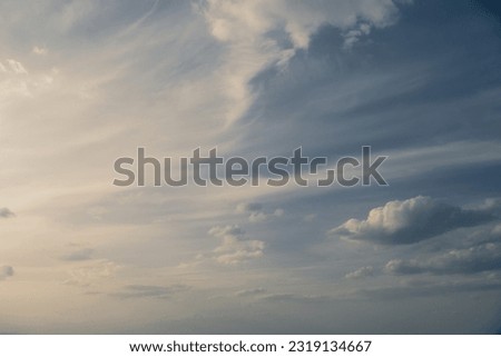 Cirrus clouds in the blue evening sky