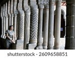 Cistercian Abbey of Santa Maria di Follina. Woman praying in the Cloister. Follina. Italy.