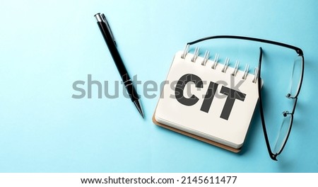 CIT text written on notepad on the blue background