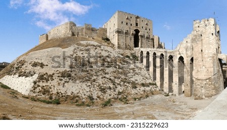 The Citadel of Aleppo is a large medieval fortified palace in the centre of the old city of Aleppo, northern Syria. It is considered to be one of the oldest and largest castles in the world.