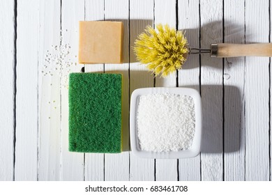 citric acid, cleaning brush, sponge and bar of soap on white wooden table background - Shutterstock ID 683461708