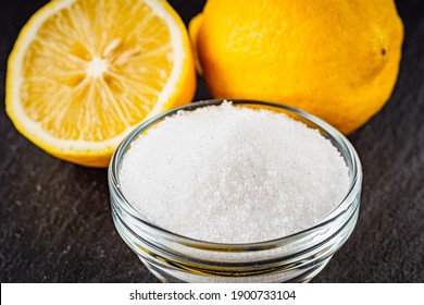 citric acid on a dark stone background. - Shutterstock ID 1900733104