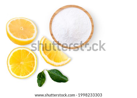 Citric acid powder or Baking soda (sodium bicarbonate powder) and lemon isolated on white background. Top view. Flat lay.