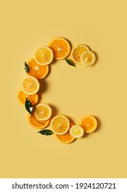 Citrus fruit food, orange and lemon shape of vitamin c flat lay on yellow background, copy space, top view, vertical
