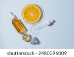 Citrus lab research. cosmetics productions, AHA components extraction. Skin care cosmetology testing. Petri dish with orange fruit slice and pipette