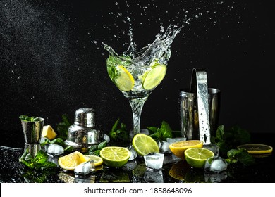 citrus refreshing drinks Lime and lemon pieces with mint and ice in water, fresh drink with liquid splash, freeze motion in jar glass on dark background. - Shutterstock ID 1858648096
