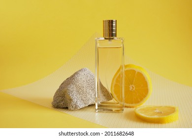 Citrus Scent, Perfume With Lemon Scent Concept, Concrete Block Fragment, Lemon Slice And Bottle Of Perfume On Yellow Background