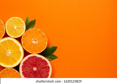 Citruses Fruits On Orange Background With Copyspace, Fruit Flatlay, Summer Minimal Compositon With Grapefruit, Lemon, Mandarin And Orange