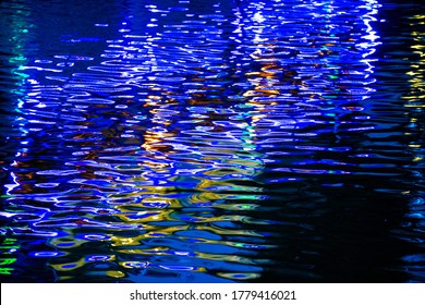 City ​​lights Above Water At Night. Long Exposure.