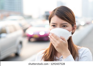 City Air Pollution Concept. Close Up Woman Wearing N95 Mask To Protect Pm2.5 Air Pollution In City