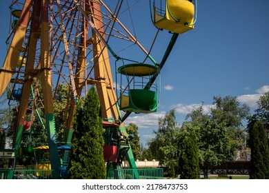 City Amusement Park. Part Of The Ferris Wheel In The Frame.