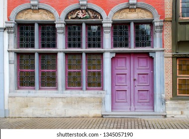 City architecture at medieval street in historical center of old town in Belgium, Europe. Front view of old town building with purple door. Beautiful background of old city for photography.