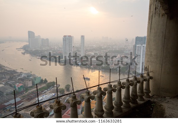 a city in asia with traffic and a river\
between skyscrapers