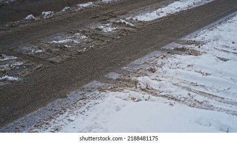 City Asphalt Street Covered In Icy Snow And Mud Frozen Slush On Winter Day