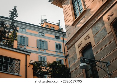 City background. View from below on the historical buildings of the city of Milan. Beautiful historical buildings against the blue sky. Milan architecture. Full frame.  - Shutterstock ID 2320659795