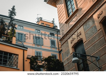 City background. View from below on the historical buildings of the city of Milan. Beautiful historical buildings against the blue sky. Milan architecture. Full frame. 