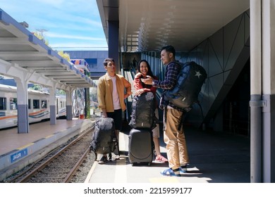 City : Bandung
Country : Indonesia
Date : 20 July 2022
Group Of Asian People Standing And Talking, Beside Railway, Waiting For The Train To Come, At Bandung Station