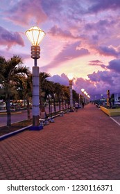 The City Baywalk Park is a seaside space for strolling located just beside the port area dotted with benches and food stalls. Dramatic sunset with purplish skies. Puerto Princesa-Palawan-Philippines.