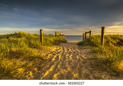 city beach sunset path sandy Port Melbourne grassy dunes fences footprints - Powered by Shutterstock