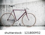 City bicycle fixed gear and concrete wall, vintage old retro bike, cycling or commuting in city urban environment, ecological transportation concept