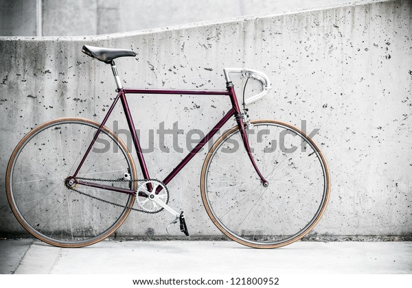 City bicycle fixed gear and\
concrete wall, vintage old retro bike, cycling or commuting in city\
urban environment, ecological transportation\
concept