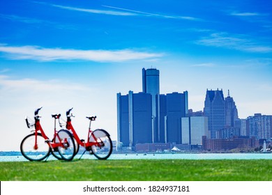 City bicycles on Sunset Point over Detroit river and view of downtown on sunny day from Belle Isle