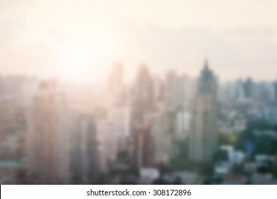 City Blur Abstract Background With Morning Gold Light Sky Rooftop View Over Cityscape With Bright Sun Flare And Bokeh In Summer Or Spring Season 