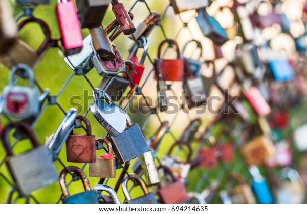 The city bridge with a lot of metal locks.\
Romantic traditions