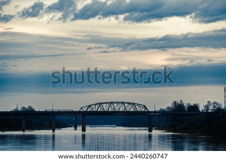 city bridge over the river under a cloudy sky nice photo