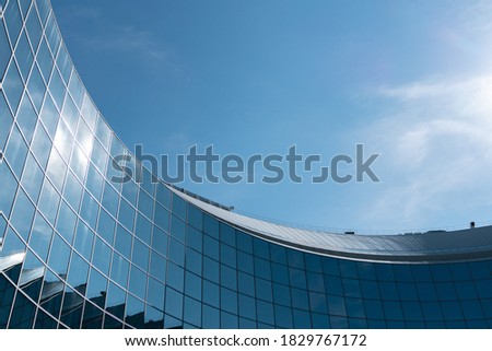 
city ​​business buildings mirror windows with blue sky reflections industry curves modern buildings abstract texture