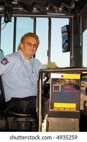 City Bus Driver At The Wheel.