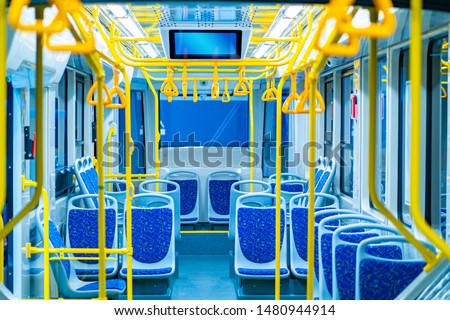 City bus. Land transport in the city. Passengers seats. Bus equipped with handrails for holding. Information screen in transport. Non-cash payment bus validators. Public urban passenger transport.