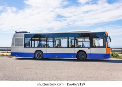 City Bus On The Side Of The Road Stop, Side View On Sky Background