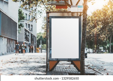 A City Bus Stop With The Clean Placeholder Template; Advertising Empty Poster Mock-up In Urban Settings; A Blank White Banner Mockup On The Wall Of The Stop Of A Public Transport Near The Road