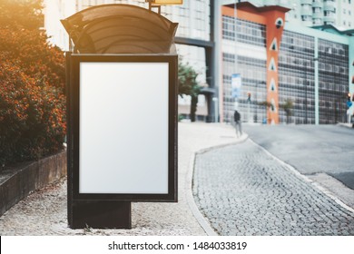 City Bus Stop On With An Empty Poster Mock-up; Template Of An Advertising Banner On The Stop Of Transport In A Residential District; Blank Placeholder Mockup On The Pavement Near A Road With Marking