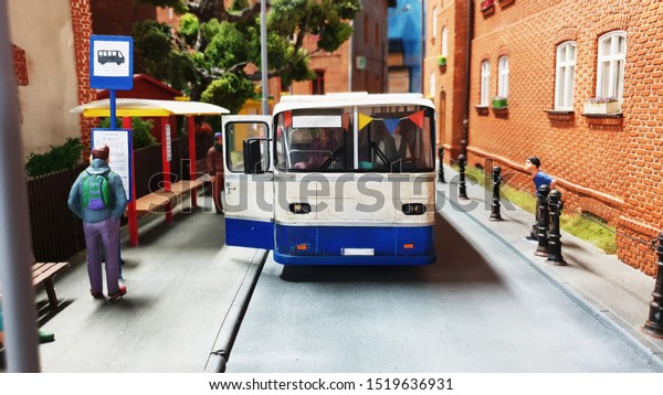 City bus toy model surrounded by model people on
the bus station. Travel
concept