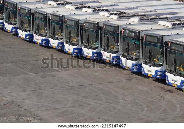City buses in a row in a parking. Row of buses in\
the parking lot. Many buses at the bus station in the city. 15\
October 2022. Tel Aviv.\
Israel