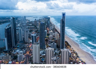 City by the beach at dusk, aerial, view from above. Surfers Paradise town, Gold Coast, Queensland, Australia at dusk, aerial view