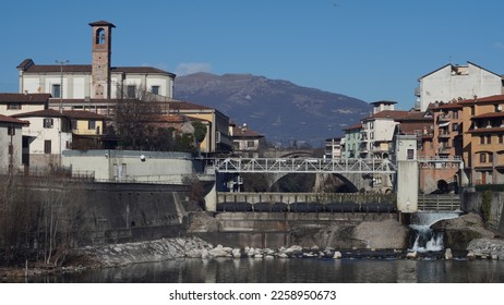City centre, towers and bell towers. Bridges and dam on the Brembo river. Municipality of Ponte San Pietro, province of Bergamo. Winter season. - Shutterstock ID 2258950673
