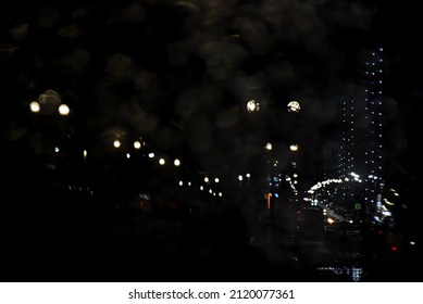 City Clad In The Light Of Night Lights In The Reflection Of The Side Mirror Of A Car.Abstract Wallpaper Design. Bokeh.