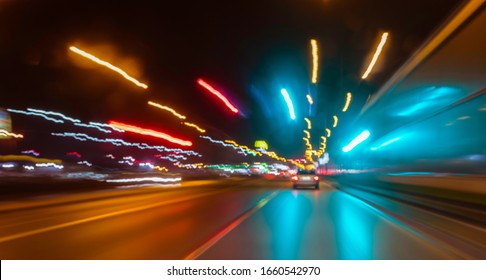 City Colorful Night Lights Perspective Blurred By High Speed Of The Car. A Streak Of Light, Trails.