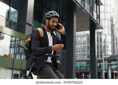 City commuter, businessman phone calling while traveling from work to home on bike. City lifestyle of single man. - Powered by Shutterstock