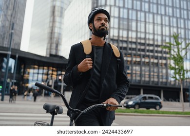 City commuter, businessman traveling from work to home on bike, wearing backpack and helmet for safety. City lifestyle of single man. - Powered by Shutterstock