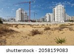 City construction among desert dunes. Building yard of Housing construction of houses in a new area of the city Holon in Israel