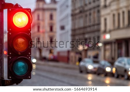 A city crossing with a semaphore. Red light in semaphore - image