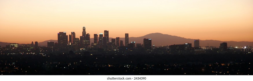 City at dawn with mountains behind