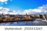 City of Derry aka Londonderry in Northern Ireland aerial view - A Beautiful Cityscape from above by the River Foyle Featuring the Beautiful Pedestrian Peace Bridge