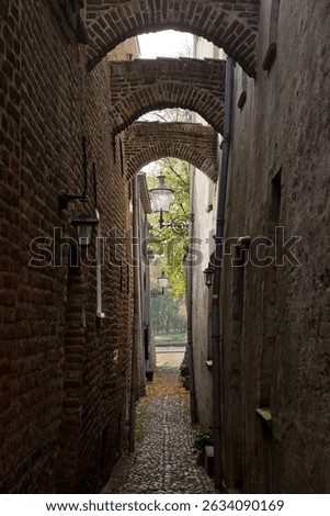 City of Deventer Netherlands. Houses and buildings at the town. Urban. Historic dutch houses and streets.Historic warehouse.Norrow medieval alley or street at 